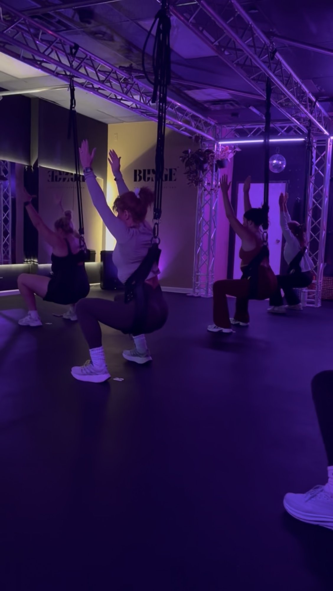 Students in a candlelit cooldown during a bungee fitness class at BUNGE Fitness